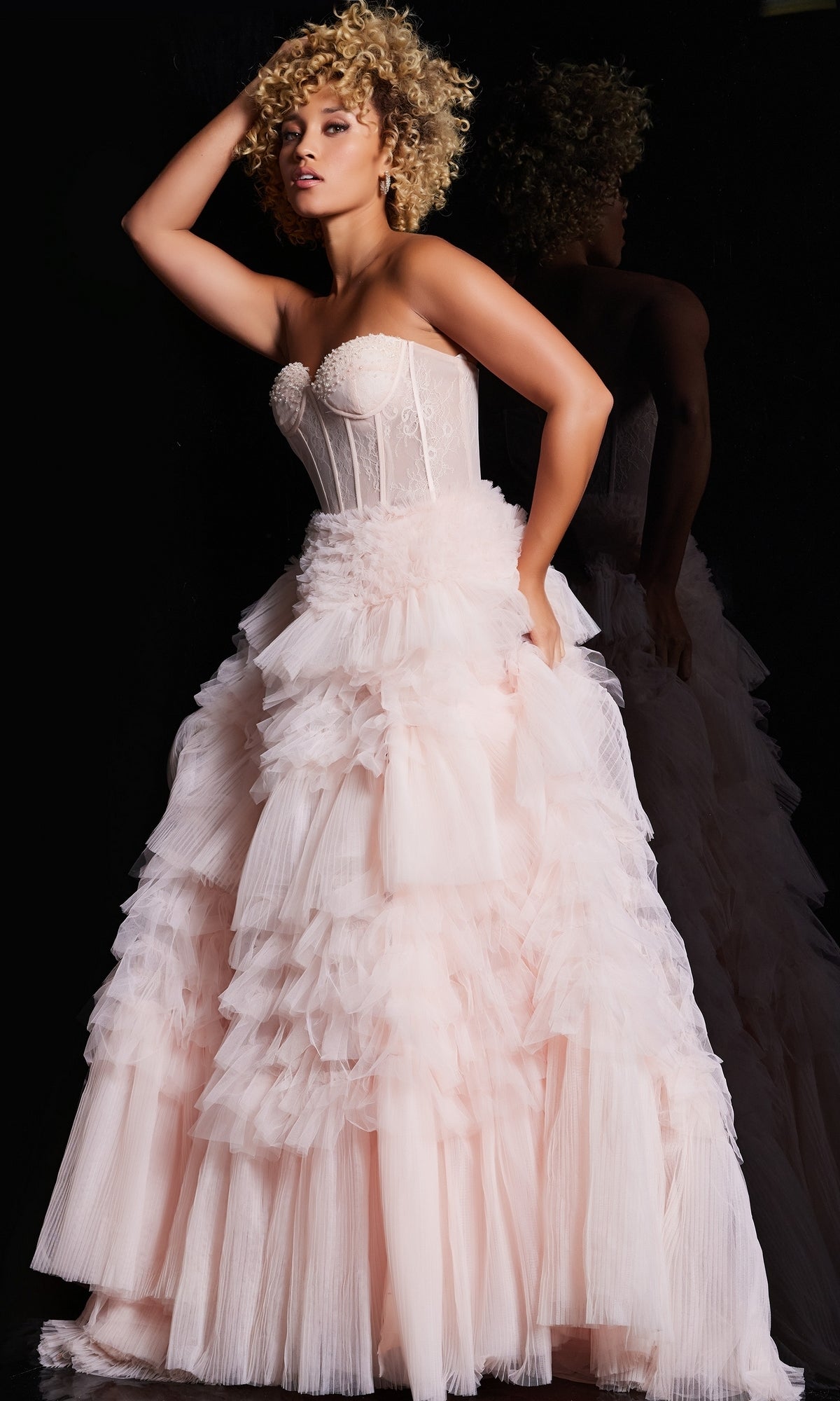 A woman in a stunning Jovani Ruffled Long Strapless Prom Ball Gown 38540.